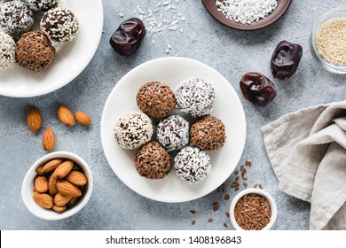 Vegan Chocolate Protein Energy Balls With Dates, Seeds And Nuts On Concrete Background. Top View. Flat Lay