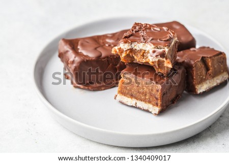 Vegan cocoa dates chocolate bars on white background. Plant based food concept.