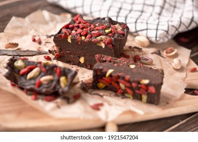 
Vegan date chocolate. Chocolate with nuts and goji berries. Homemade sweets.