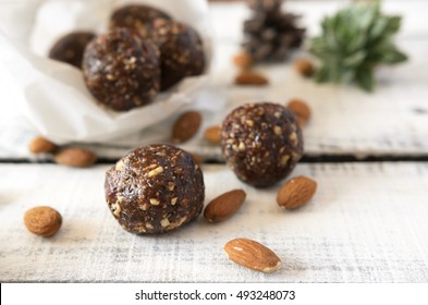 Vegan delicious sweet cocoa and almond balls on wooden table healthy food
