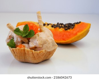 Vegan Dessert. Papaya And Banana Sorbet On The Background Of Half Of The Fruit.