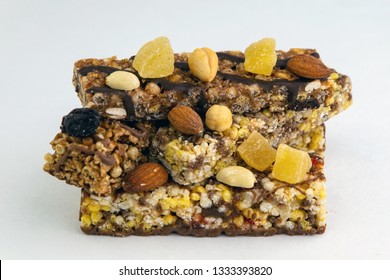 vegan dessert: several cereal bars with nuts, raisins and honey, on white, short focus - Shutterstock ID 1333393820
