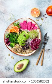 Vegan, detox Buddha bowl with quinoa, micro greens, avocado, blood orange, broccoli, watermelon radish, alfalfa seed sprouts. Top view, flat lay, copy space 