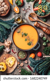 Vegan Diet. Autumn Harvest. Healthy, Clean Food And Eating Concept. Zero Waste. Pumpkin Soup With Vegetarian Cooking Ingredients, Wooden Spoons, Kitchen Utensils On Wooden Background. Top View