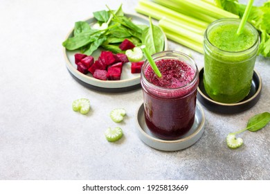 Vegan diet and nutrition, healthy detox, vegetarian concepts drinks. Beet smoothie and Green smoothie celery and spinach on a gray stone countertop. Copy space.