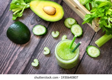 Vegan diet and nutrition, healthy detox, vegetarian concepts drinks. Green smoothie celery, avocado, cucumber and spinach on a rustic table. Top view flat lay. 
