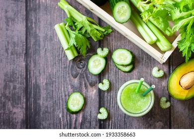 Vegan diet and nutrition, healthy detox, vegetarian concepts drinks. Green smoothie celery, avocado, cucumber and spinach on a rustic table. Top view flat lay. Copy space.