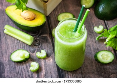 Vegan diet and nutrition, healthy detox, vegetarian concepts drinks. Green smoothie celery, avocado, cucumber and spinach on a rustic table.