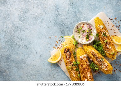 Vegan dinner with grilled sweet cob corn top view with copy space Summer vegetarian snacks