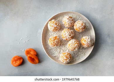 vegan energy balls with dried apricots and coconut in ceramic plate. vegan alternative food. Gray background. top view. copy space - Shutterstock ID 1979645768