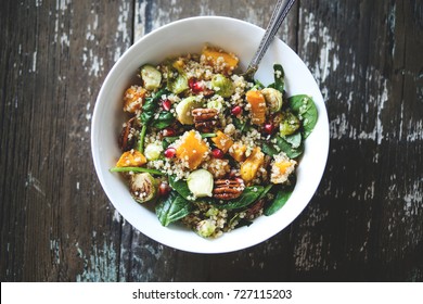 Vegan fall salad with squash, brussels sprouts, and pomegranate seeds