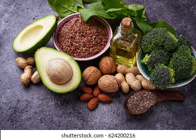 Vegan fat sources  flax, spinach, broccoli, nuts, olive, oil and avocado. Concept of healthy food - Shutterstock ID 624200216
