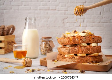 Vegan Food French Toast With Peanut Butter, Honey Syrup And Banana On Wooden Plate.