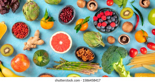 Vegan Food Panorama. Healthy Diet Concept. Fruits, Vegetables, Nuts, Legumes, Mushrooms, Shot From The Top On A Blue Background, A Flatlay