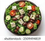 Vegan Greek Salad with Mixed greens with cucumbers, tomatoes, olives, and vegan feta cheese.