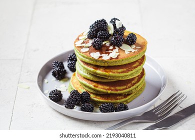 Vegan Green Matcha Pancakes With Blackberries, Syrup And Almonds. Plant-based Recipe, Healthy Breakfast, Alternative Food Concept.