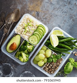 Vegan Green Meal Prep Containers With Quinoa, Rice, Avocado And Vegetables Overhead Shot With Copy Space