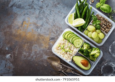 Vegan Green Meal Prep Containers With Quinoa, Rice, Avocado And Vegetables Overhead Shot With Copy Space