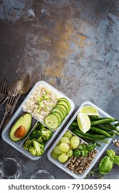 Vegan Green Meal Prep Containers With Quinoa, Rice, Avocado And Vegetables Overhead Shot With Copy Space