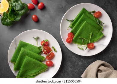 Vegan Green Spinach Thin Pancakes With Fresh Vegetables On Dark Background. Alternative Dairy Free Diet, Plant Based Food. Top View