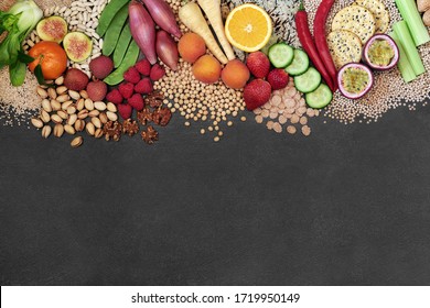 Vegan health food background border with a large selection of foods. High in protein, vitamins, minerals, antioxidants, anthocyanins, fibre, omega 3 and smart carbs. Ethical food concept. Flat lay.