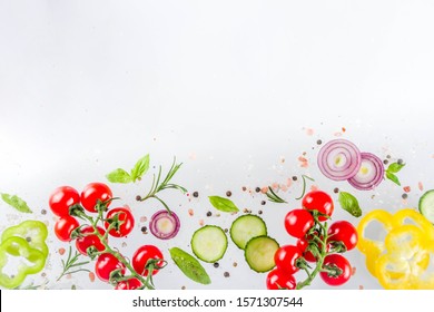 Vegan healthy food concept. Ingredients cooking spring vitamin salad. Fresh vegetable simple pattern, layout with tomatoes, onions, herbs and spices on white background. Top view banner copy space - Shutterstock ID 1571307544