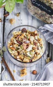 Vegan Keto Granola Made With Pecans, Hazelnuts, Unsweetened Coconut, Sunflower Seeds, Pepita Seeds And Sweetened With Erythritol. Served With Low Carb Almond Milk. Top View Over A White Wooden Table.