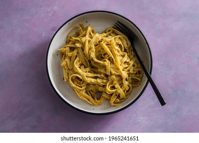 Vegan Lemon And Herbs Sauce Fettuccini Pasta On Pink Background, Healthy Plant-based Food Recipes