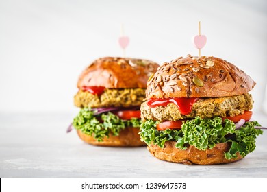 Vegan lentil burgers with kale and tomato sauce on a white background. Plant based food concept. - Shutterstock ID 1239647578