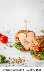 Vegan lentil burgers with kale and tomato sauce on a white background. Plant based food concept. - Shutterstock ID 1246904626