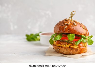 Vegan lentils burger with vegetables and curry sauce. Light background, copy space. Vegan food concept. - Shutterstock ID 1027979104