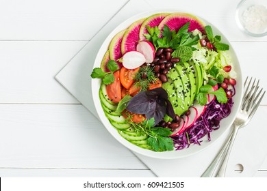 Vegan Lunch Bowl. Avocado, Red Bean, Tomato, Cucumber, Red Cabbage  And Watermelon Radish  Vegetables Salad. Healthy Food. Top View