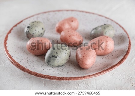 Vegan marzipan Easter eggs candy on a plate. Sugar, gluten and lactose free.
