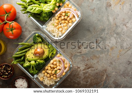 Vegan meal prep containers with cooked rice, chickpeas and vegetables