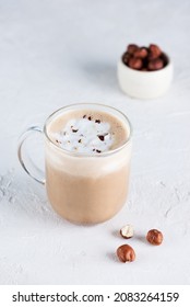 Vegan mochaccino with chocolate, hazelnuts and coconut milk in a glass mug.