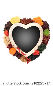 Vegan natural health food diet with heart shaped frame. High in flavonoids, polyphenols, fibre, anthocyanins, bioflavonoids, lycopene, antioxidants. On white with gradient chalkboard. 