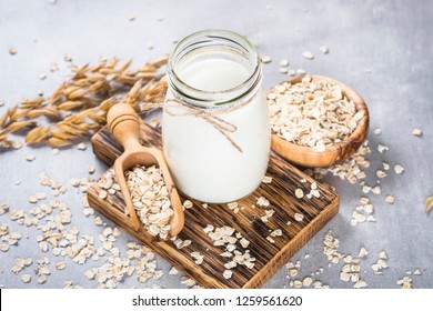 Vegan Non Dairy Alternative Milk. Oat Flakes Milk On Stone Table.