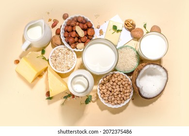 Vegan non-dairy products. Plant-based alternative dairy products – milk, cream, butter, yogurt, cheese, with ingredients - chickpeas, oatmeal, rice, coconut, nuts - Shutterstock ID 2072375486