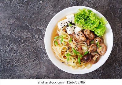 Vegan Noodle Soup With Tofu Cheese, Shiitake Mushrooms And Lettuce In White Bowl. Asian Food. Top View. Flat Lay