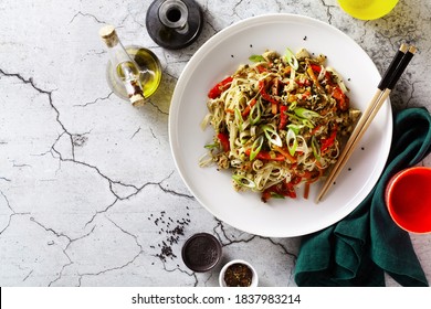 Vegan Pad Thai Rice Pasta With Vegetables And Tofu On Gray Concrete Background With Soy Sauce And Sesame Oil