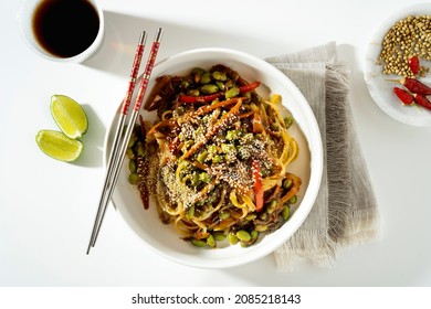 Vegan Pad Thai With Tofu And Edamame Beans In A White Plate