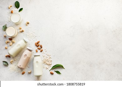 Vegan plant based milk and ingredients, top view, copy space. Various dairy free, lactose free nut and grains milk, substitute drink, healthy eating. - Shutterstock ID 1808755819