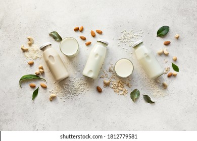 Vegan plant based milk and ingredients, top view, copy space. Various dairy free, lactose free nut and grains milk, substitute drink, healthy eating. - Shutterstock ID 1812779581