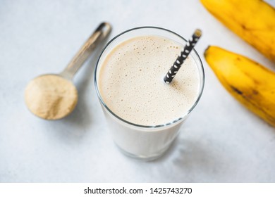 Vegan Protein Banana Shake Or Smoothie In Glass. Top View, Selective Focus