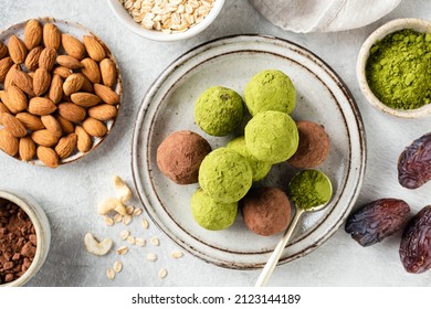 Vegan protein matcha green tea balls or truffles on a plate. Homemade healthy sweets