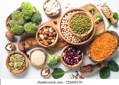 Vegan Protein Source. Beans, Lentils, Nuts, Broccoli Spinach And Seeds. Top View On White Table. Healthy Vegetarian Food.