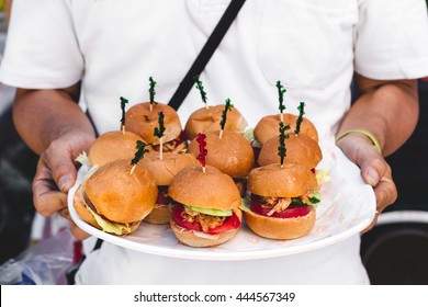 Vegan Pulled Pork Sliders On A Plate Held By A Server At A Vegan Food Festival 