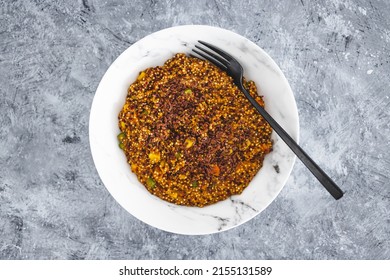 vegan quinoa with corn peas and carrots wit red pesto and flaxseeds topping, healthy plant-based food recipes