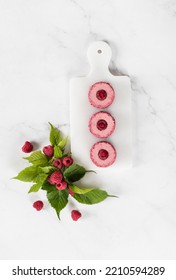 Vegan Raspberry Mousse Cream Cake, In The Form Of Round Sweet Japanese Sushi, On A Serving Board. White Background. Top View