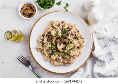 Vegan Risotto With Champignons And Parsley On A White Plate On A Light Background